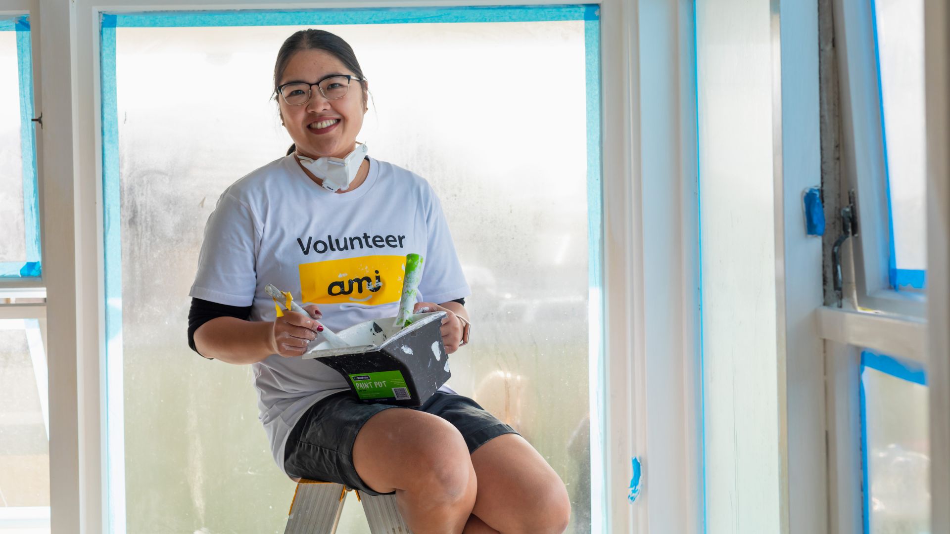 AMI Insurance volunteers painting an Otara home in partnership with Habitat for Humanity's Home Repair programme