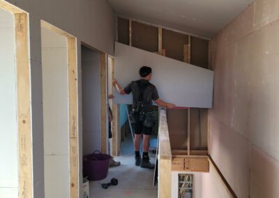 Putting gib on the inside of the second floor of Richmond PHO homes__Habitat Nelson_August 2023