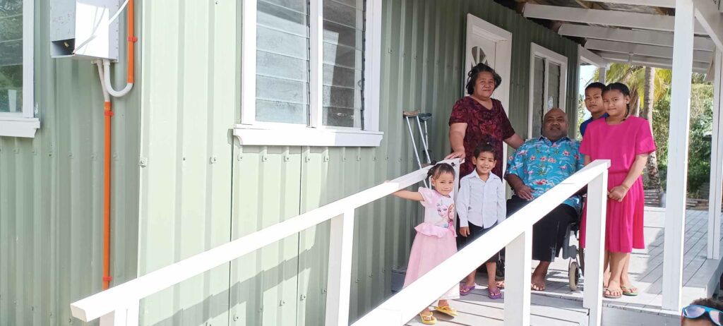 Tongan family standing on the deck of their disability-friendly home. 
