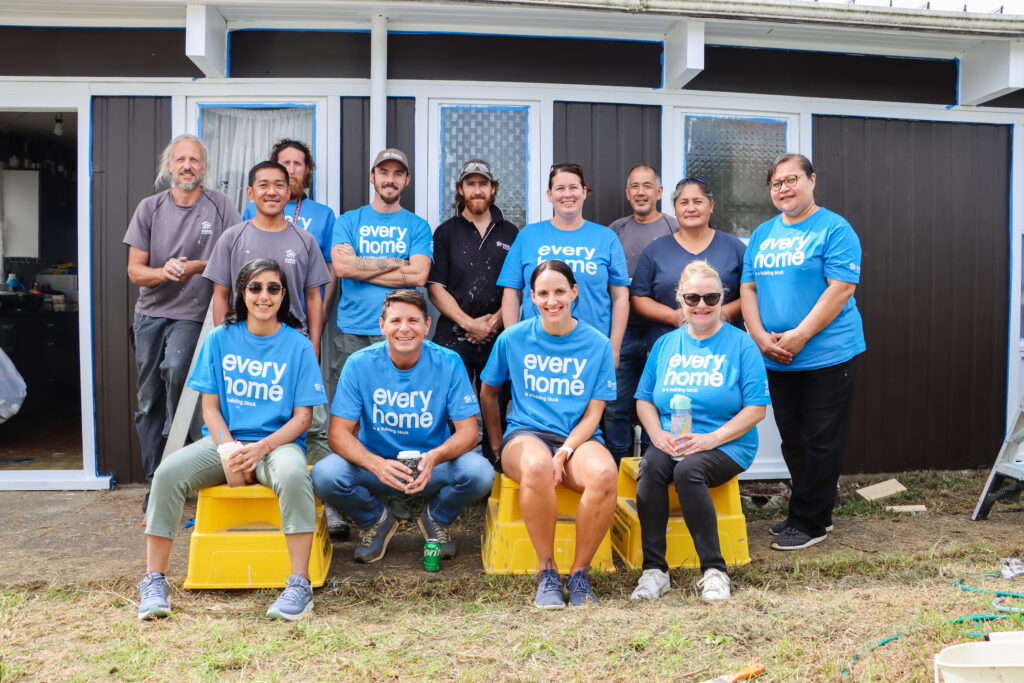 Group photo of volunteers while on-site at a home repair day. 